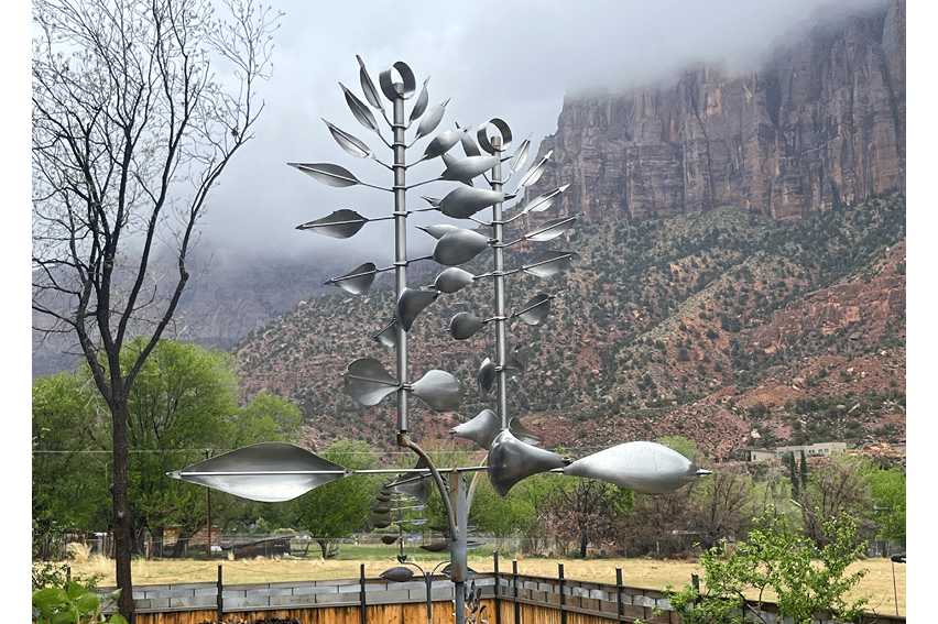 A metal sculpture of a flower with many petals. Description generated by AI