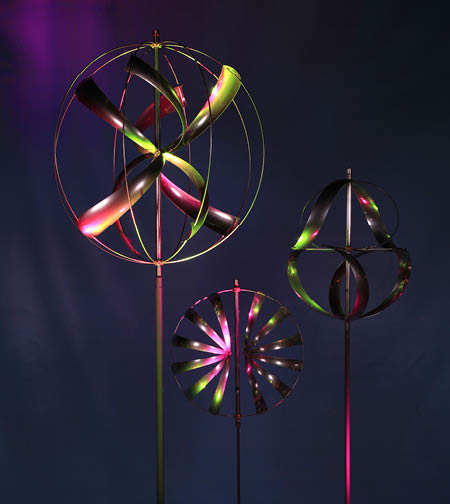 Three colorful wind catchers are on display. Description generated by AI