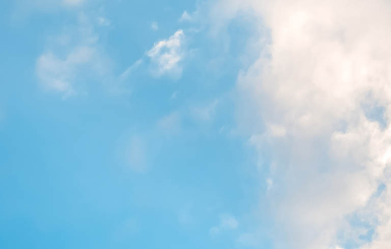 A cloudy blue sky with a few clouds. AI generated content