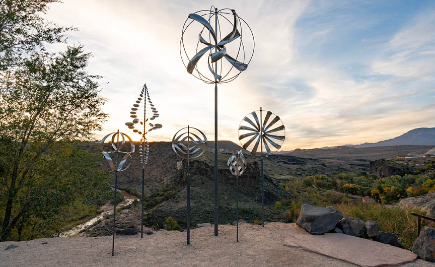 A group of windmills on a rocky hillside. Description generated by AI