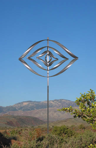 A metal sculpture of a circle with a hole in the center is displayed in a field. AI generated content