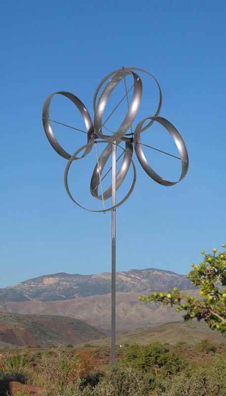 A large metal sculpture of a flower is standing in a field. AI generated content