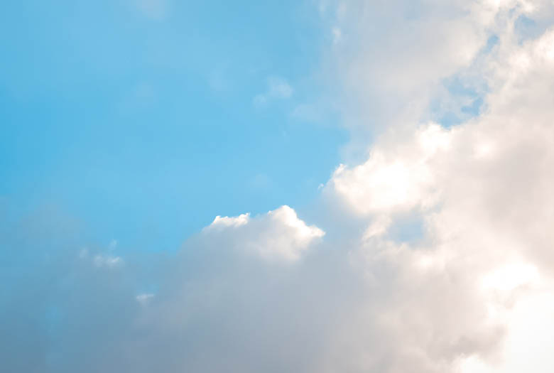 A cloudy blue sky with a few clouds. AI generated content