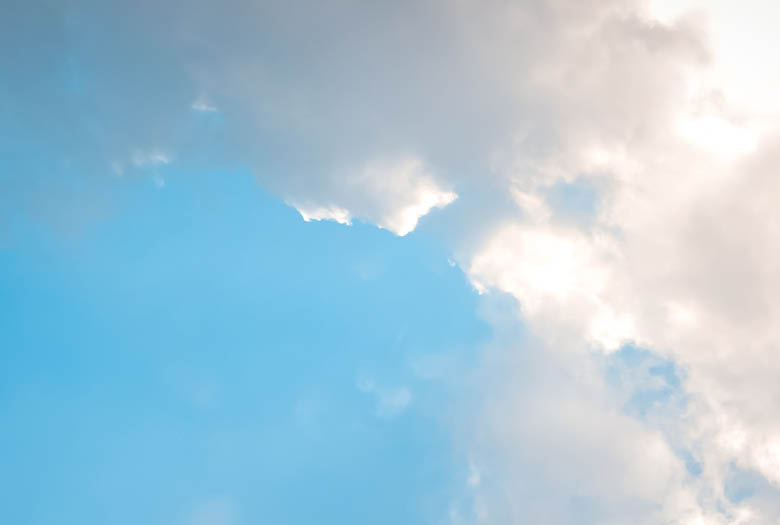 A cloudy blue sky with a few clouds. AI generated content