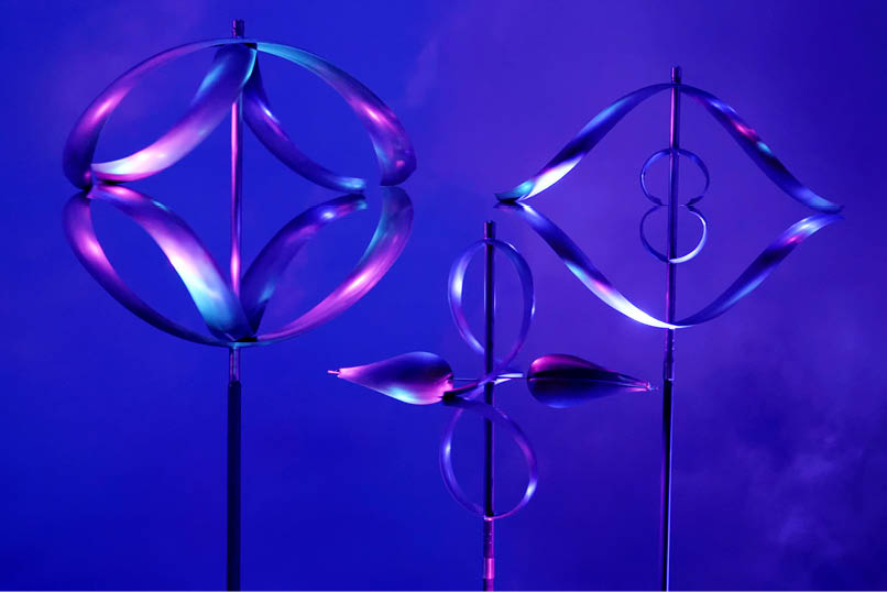 Three sculptures of different shapes and sizes are displayed on a purple background. AI generated content